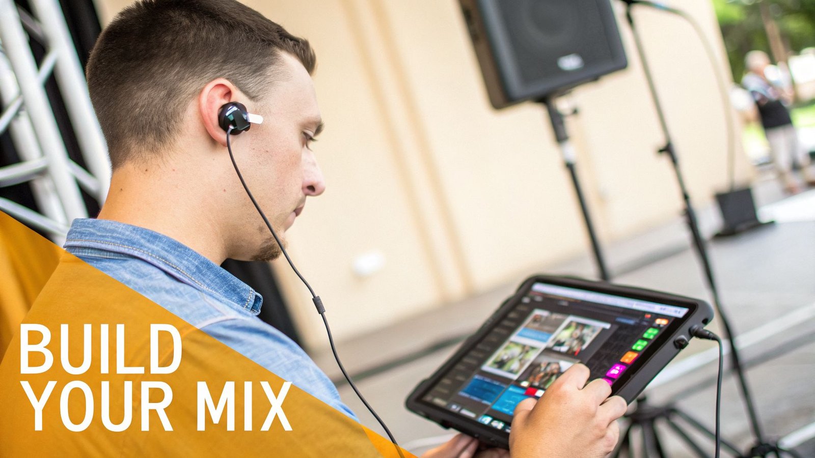 A man wearing in-ear monitors uses a tablet for sound mixing, with event equipment in the background.